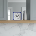 Big Railway Blue Square Kitchen Wall Clock with Dutch Design and Functional Design displayed on wooden shelf in modern kitchen.