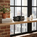 Black digital flip clock on a white background