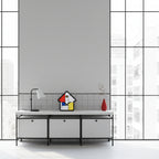 Preorder - Mondrian Cuckoo Clock on modern minimalist cabinet with lamp and red vase showcasing Dutch Design functional design.