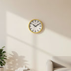 Factory Yellow XL Clock with minimalist black hands and markers, Dutch Design, mounted on a light-colored wall in modern decor.