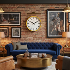 Factory Yellow XL Clock hangs on brick wall above blue sofa in stylish living room featuring Dutch Design and Functional Design elements.