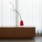 Drop Teardrop Glass Vase – Red with minimalist branch on wooden sideboard in bright, modern room, Dutch Design, Functional Design.