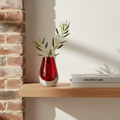 Drop Teardrop Glass Vase – Red with green leafy stems on wooden shelf beside architecture books, Dutch Design, Functional Design
