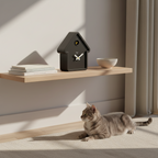 MoMA House Black Cuckoo Clock on shelf in minimalist room with cat, showcasing Dutch Design and Functional Design style.