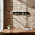 Timeline Military Time Flip Clock mounted on exposed brick wall above wooden desk with plant and books, Dutch Design functional style.