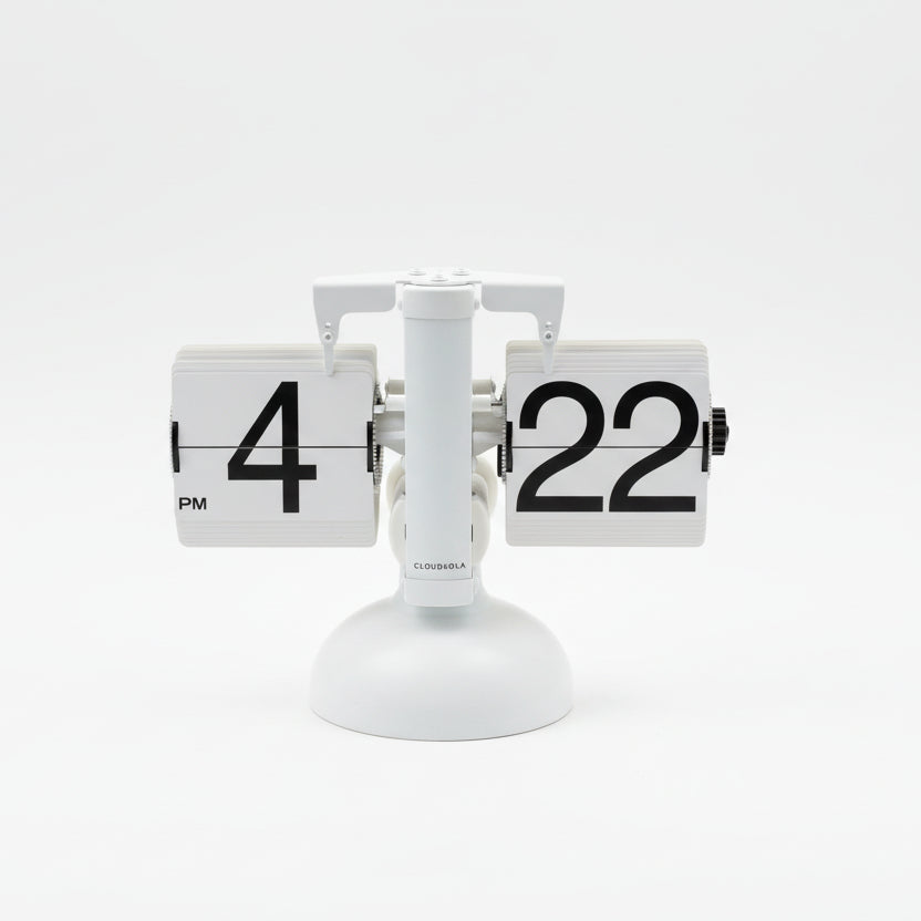 Digital clock displaying the time '4:22' on a wooden surface with blinds in the background.